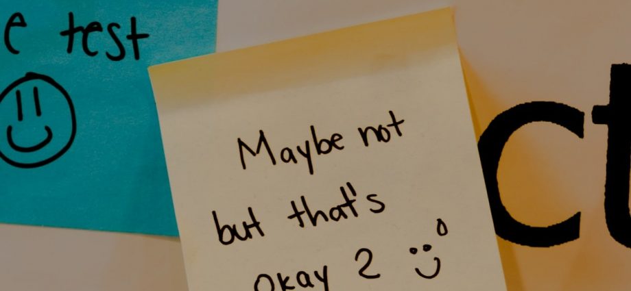 a sticky note attached to a bulletin board